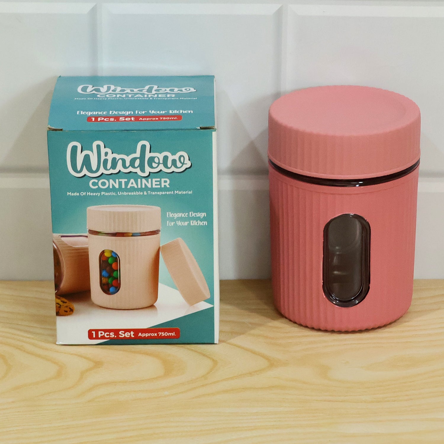 Pink ribbed storage jar with window on a wooden surface
