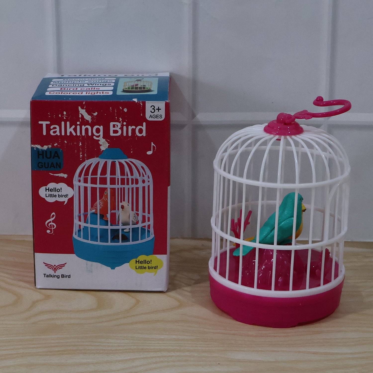 Kids happily holding a lightweight talking bird cage toy with blinking lights and sound.