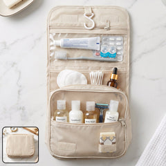 A beige hanging toiletry bag filled with travel-sized toiletries, including shampoo, conditioner, and body wash bottles.
