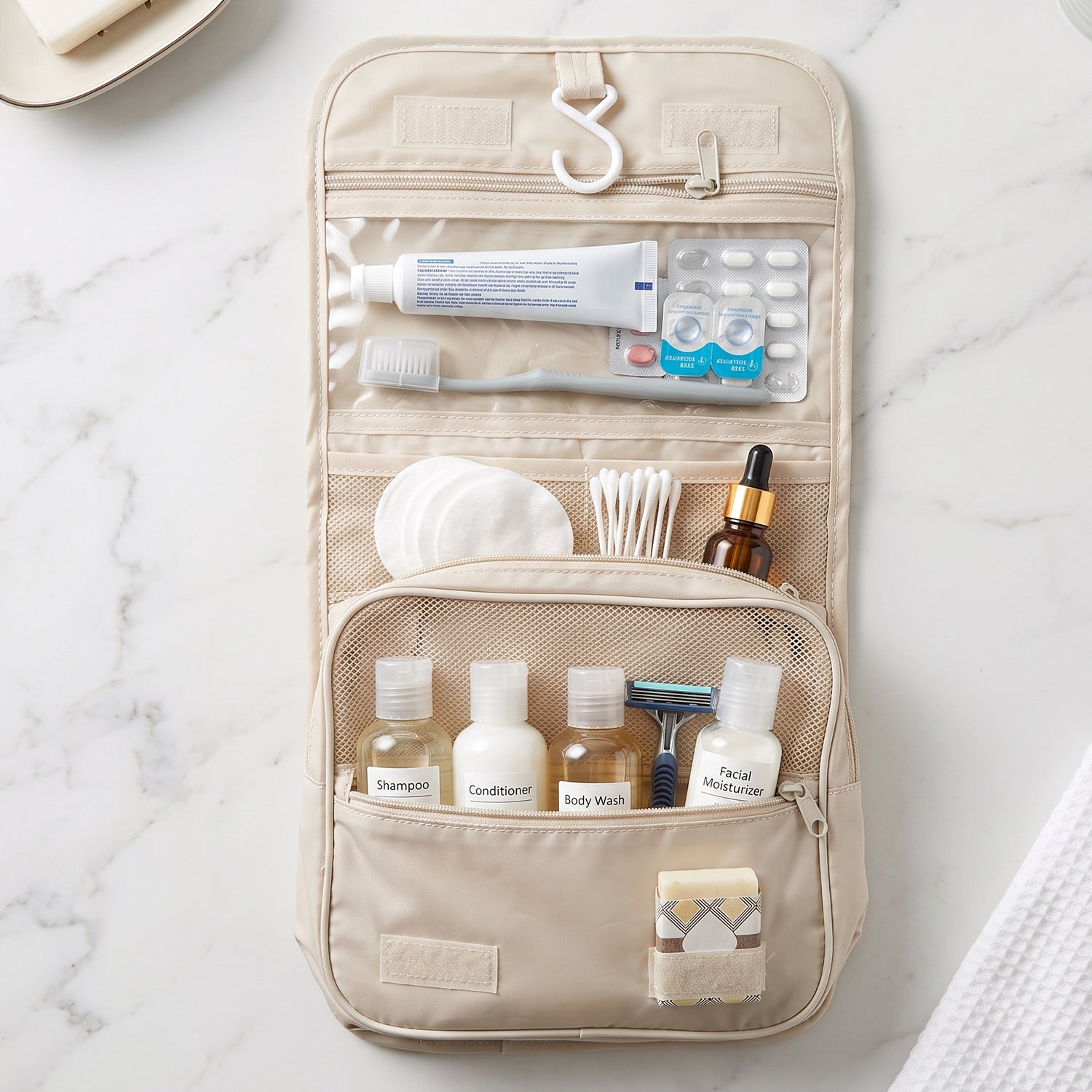 An open beige toiletry bag hanging, displaying multiple compartments with various personal care items.
