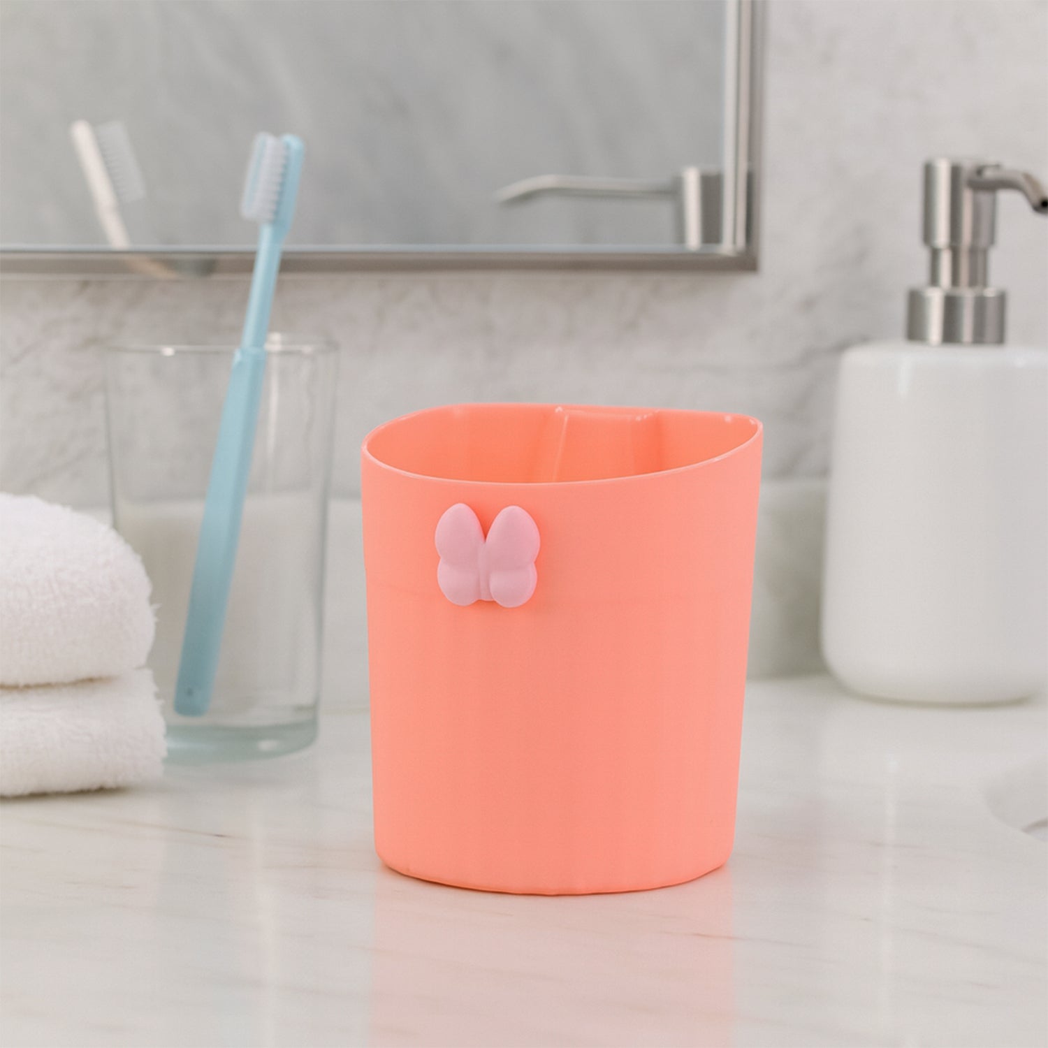 Toothbrush holder mounted on a bathroom wall, showing adhesive