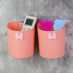 Close-up of butterfly design toothbrush holder with two toothbrushes