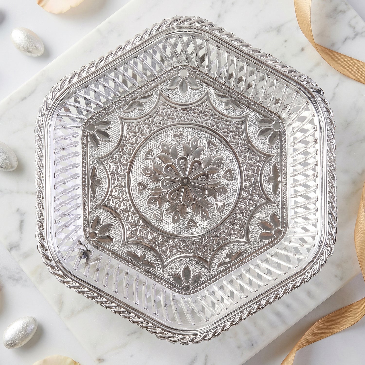 Beautiful silver tray with footed base and intricate floral embossing for serving and decoration
