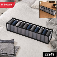 A gray 11-section fabric organizer with rolled socks on a white bedspread, with a red "11 Section" label and a black "22949"