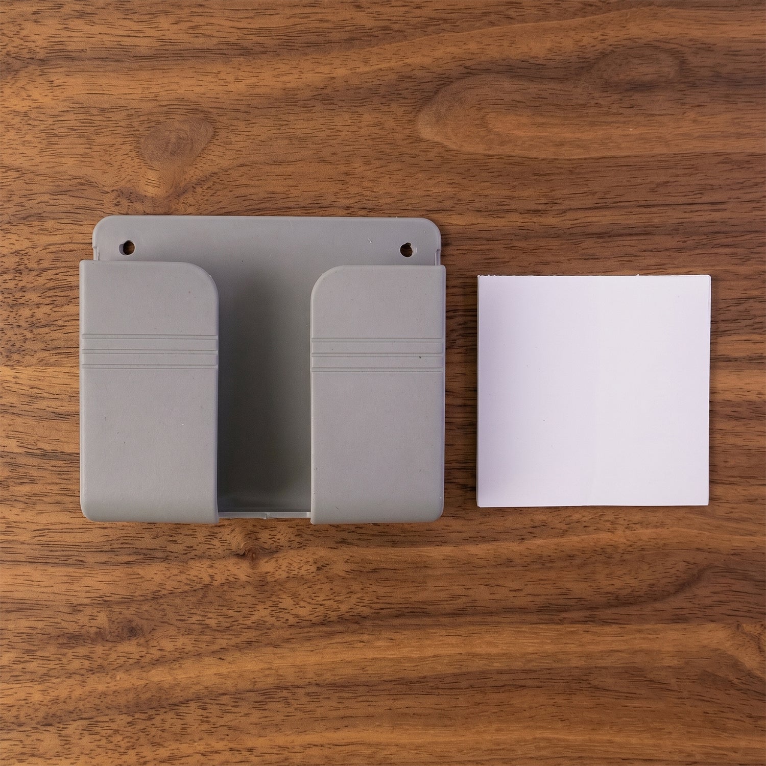 Wall-mounted device holder in modern home setting