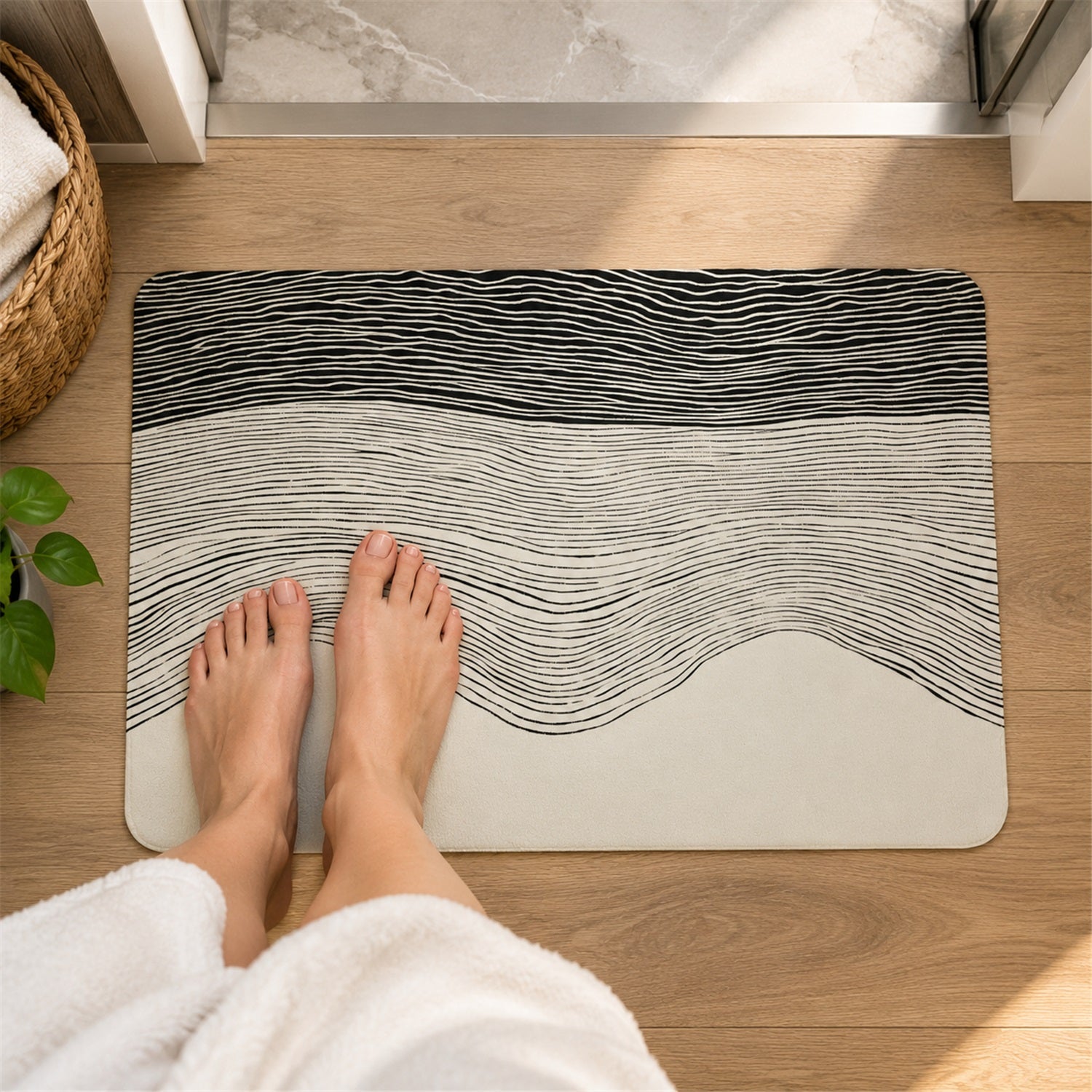 A person's feet are positioned on a rectangular mat with a black and white wavy line pattern, on a wooden floor.