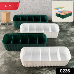 Four 5-compartment drawer organizers in a drawer, neatly storing folded socks
