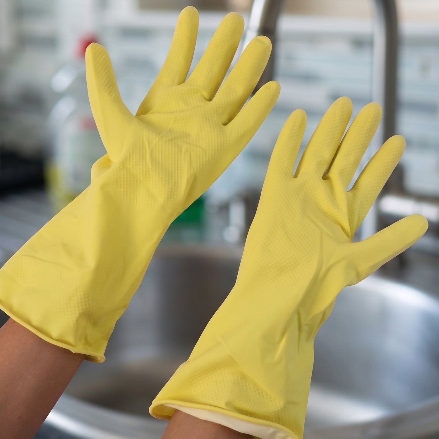 Close-up of medium yellow cleaning gloves