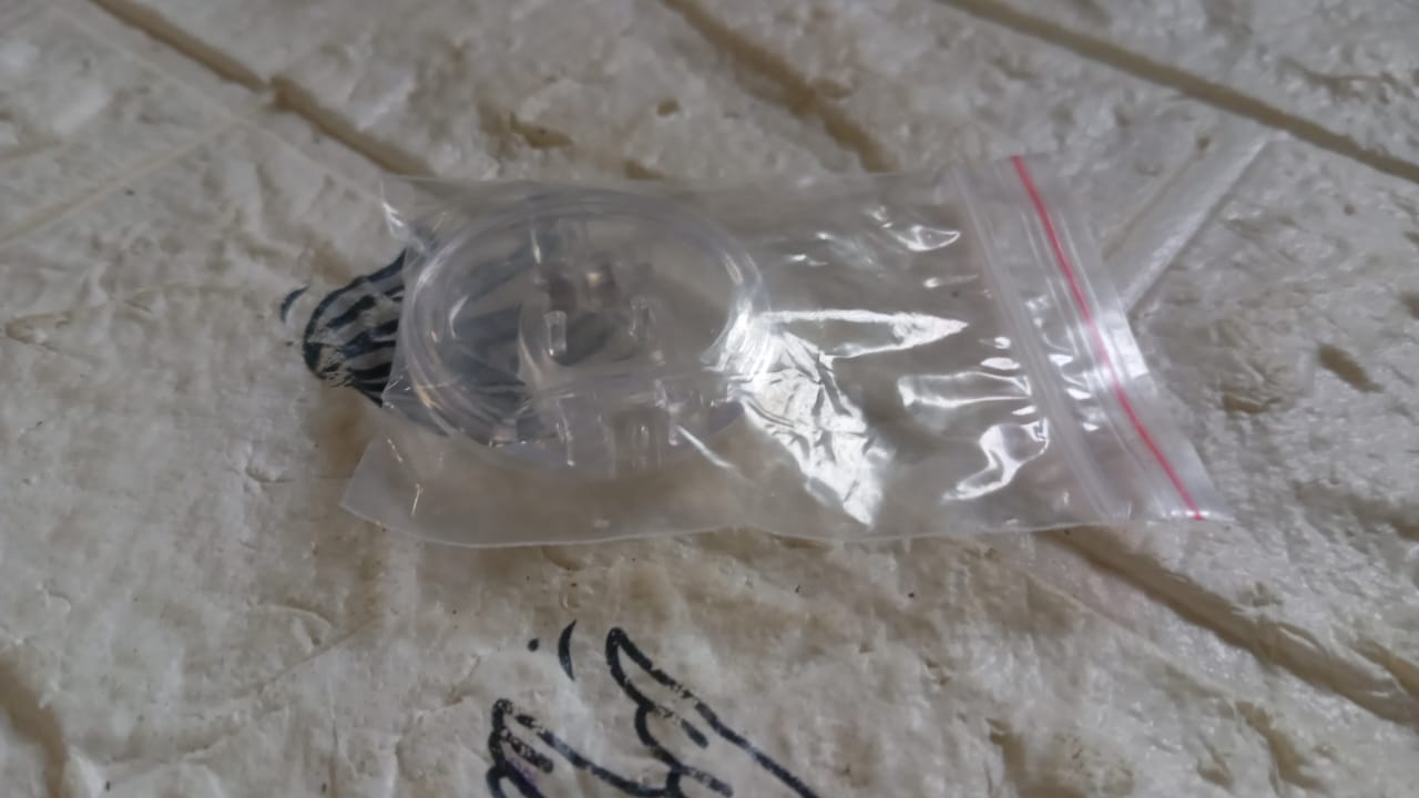 Silicone magnetic nose clip resting on surface