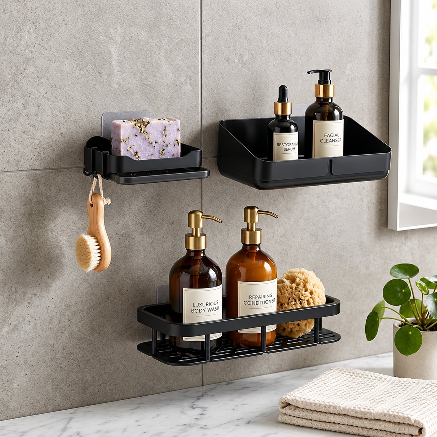 Three black plastic shower caddies with assorted bath products and a small green plant on a grey tiled wall.