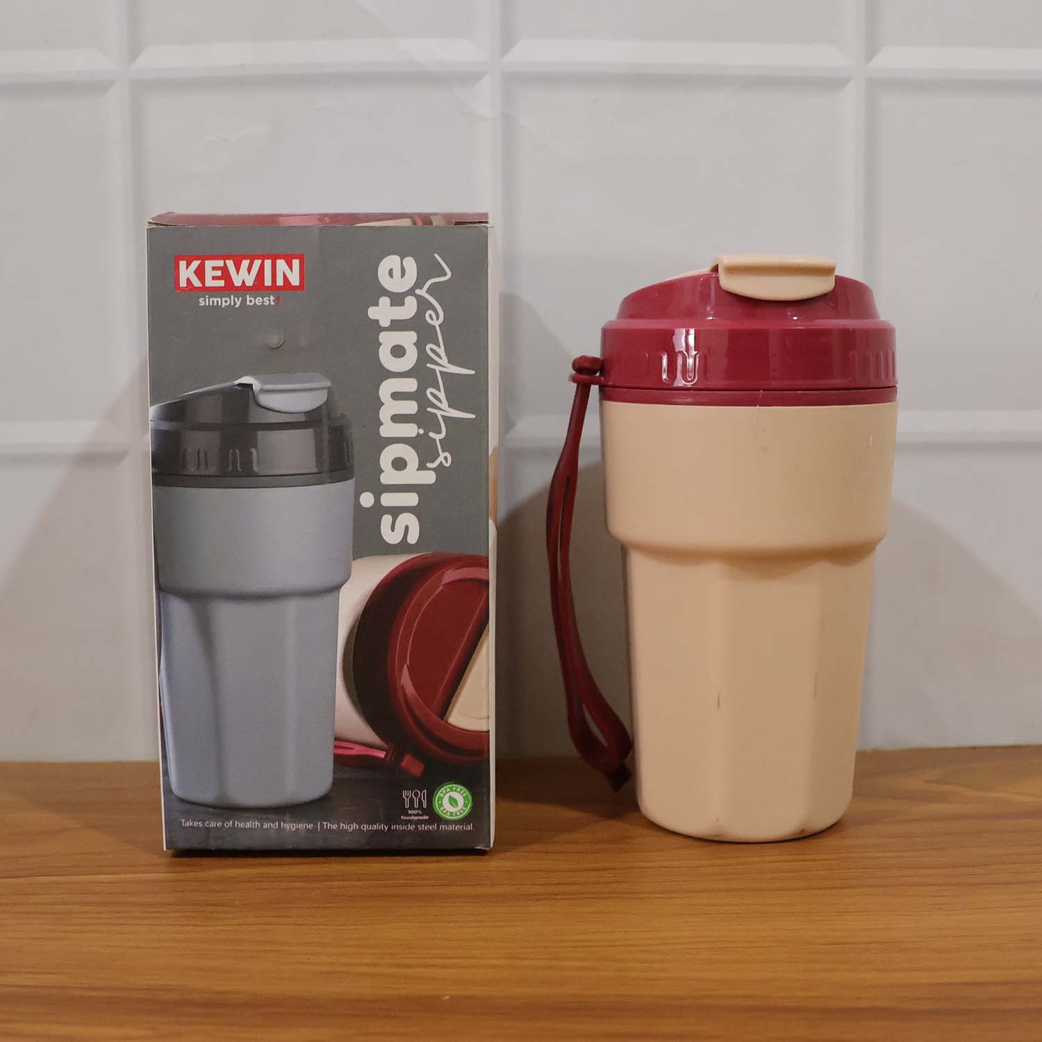 Reusable plastic sipper bottle filled with water