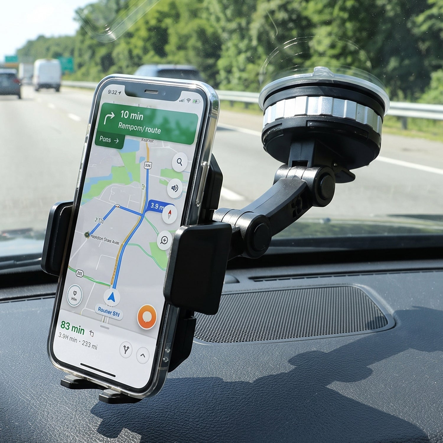A clear-cased phone is held by a black car mount phone holder with a suction cup, displaying a map on a highway.