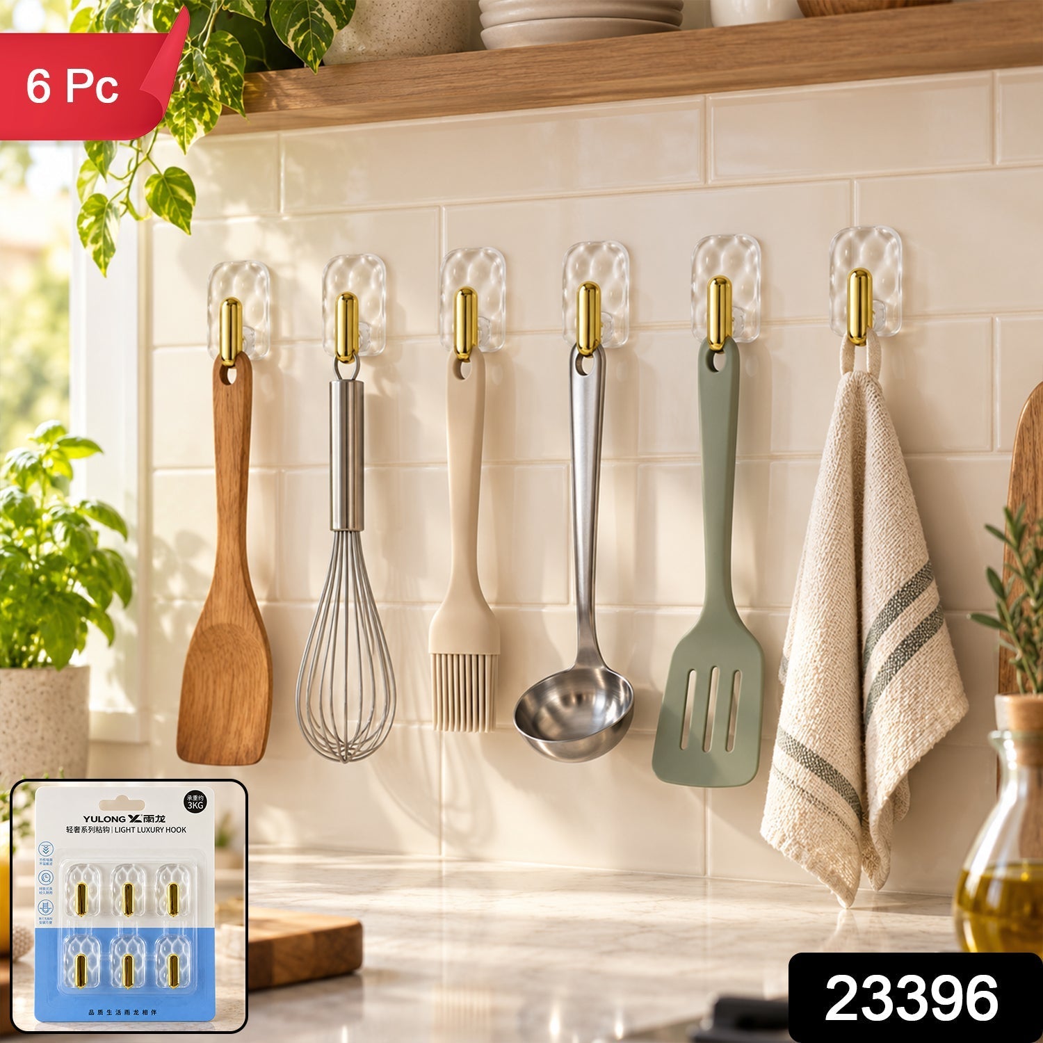 Six clear plastic hooks with gold accents hold kitchen utensils and a towel on a white tiled wall, with the product