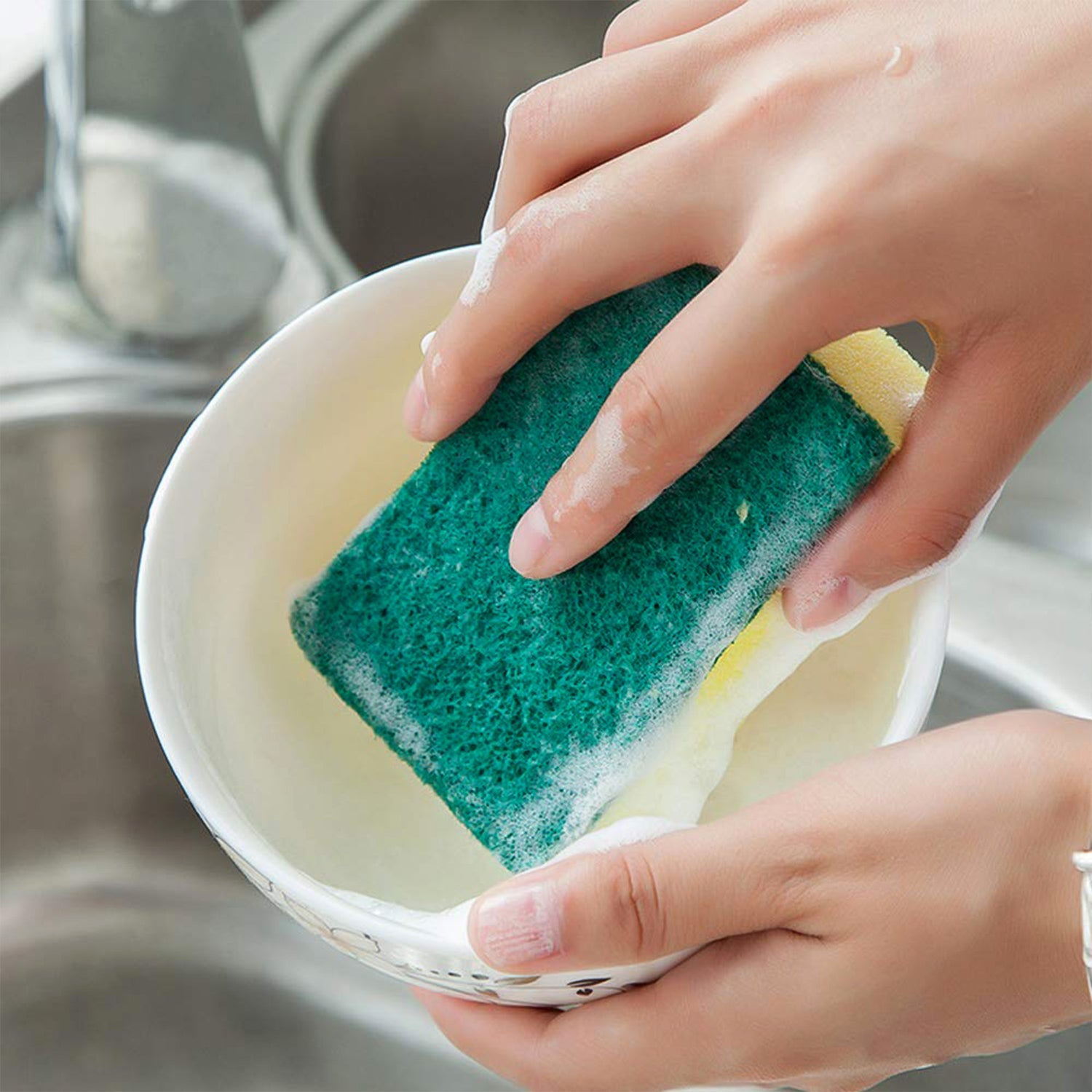 Scrub sponge removing tough stains on a kitchen dish
