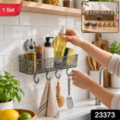 A person places a clear grey plastic shower caddy with four hooks onto a white tiled wall, filled with various â€“ view 2