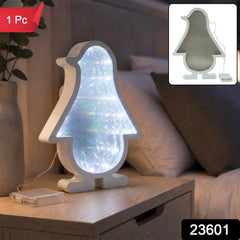 White penguin-shaped infinity mirror light with bright LED illumination, sitting on a wooden nightstand next to a â€“ view 2