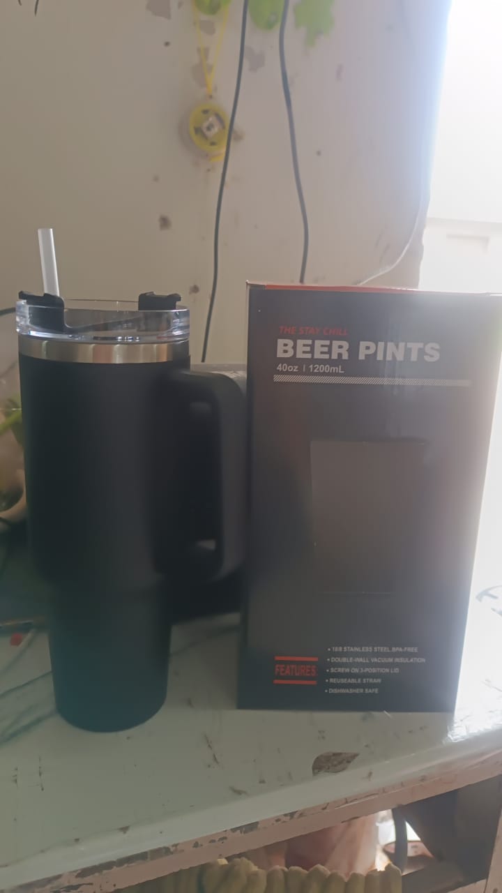 Stainless steel travel mug angled view with lid and handle