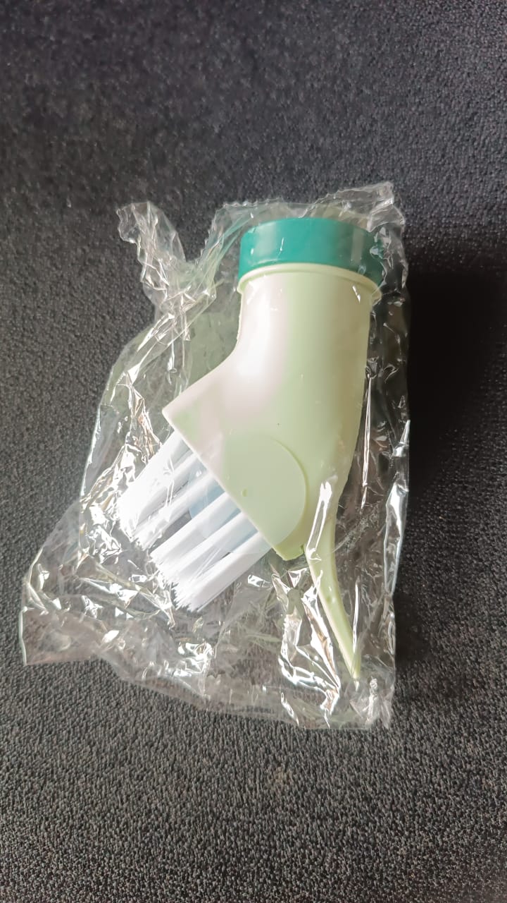 Cleaning brush connected to bottle for easy water dispensing