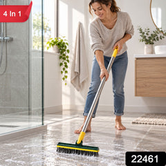 A woman in jeans and a sweater scrubs a tiled bathroom floor with a green and yellow brush, with a '4 in 1' label.