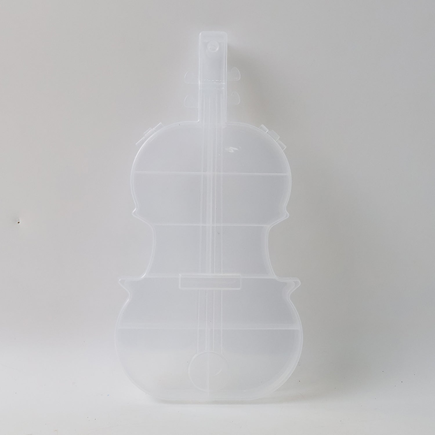 Compact violin-shaped storage container for small accessories