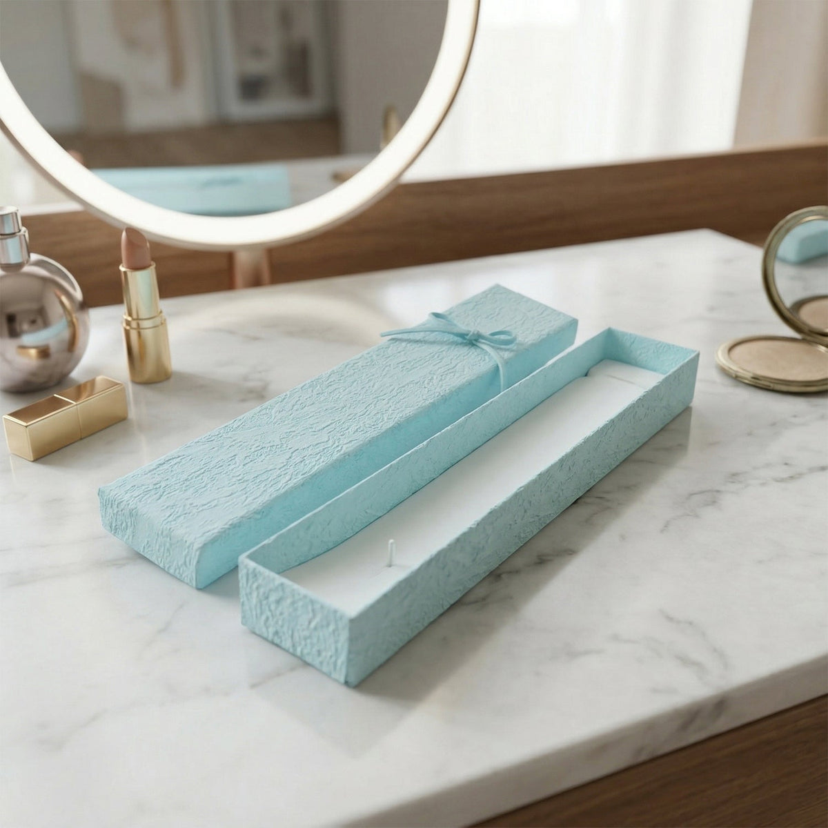 Long rectangular jewelry box with decorative ribbon closure