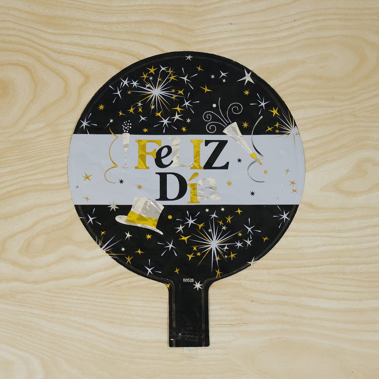 Black gold feliz balloon in use
