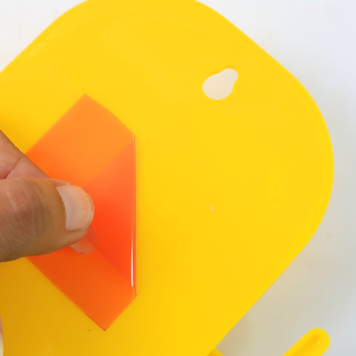 Close-up of wall-mounted mobile stand with hook