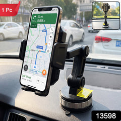 A black phone holder is mounted on a car dashboard, holding a smartphone displaying a navigation app.