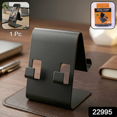 Black metal phone stand holding smartphone on desk
