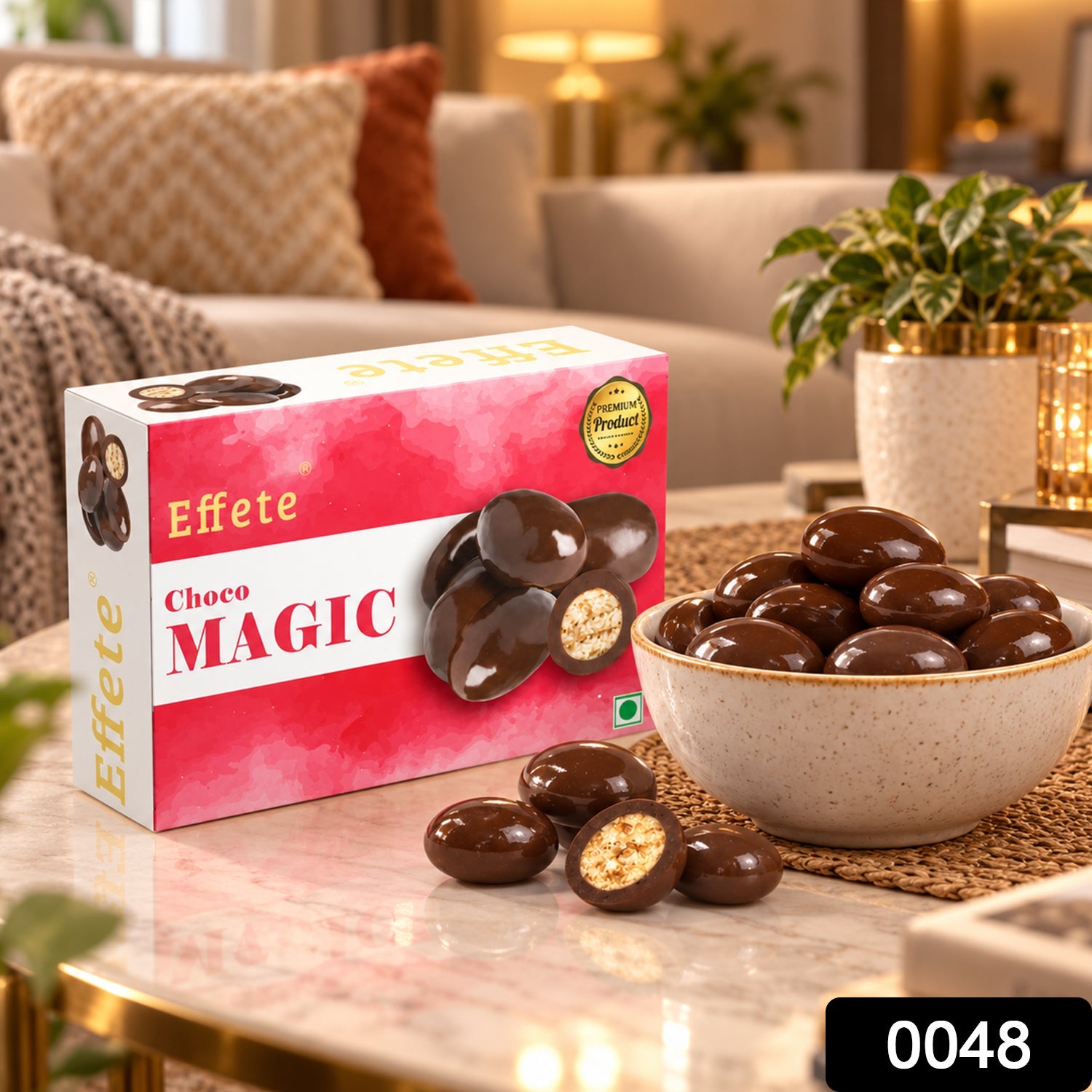 A box of Effete Choco Magic and a bowl of chocolate candies with one cut open, on a coffee table in a living room setting.