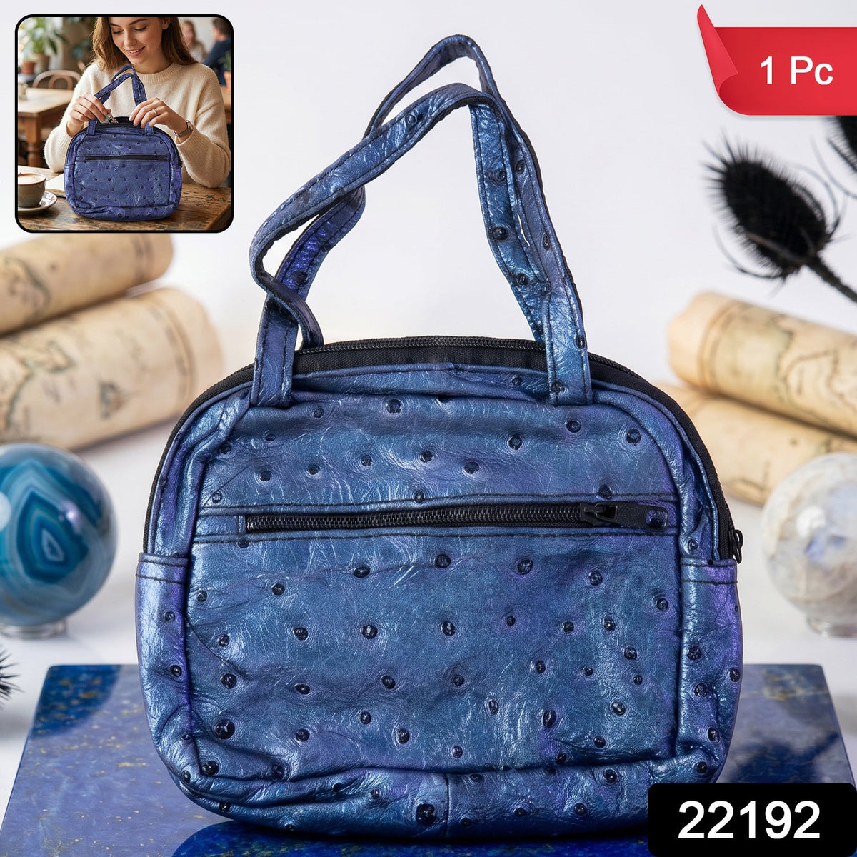 Mini zipper handbag in metallic blue ostrich pattern with dual handles and front zip pocket