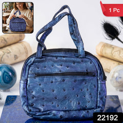 Mini zipper handbag in metallic blue ostrich pattern with dual handles and front zip pocket