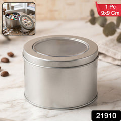 Close-up of a round metal tin with transparent lid, perfect for small item storage.