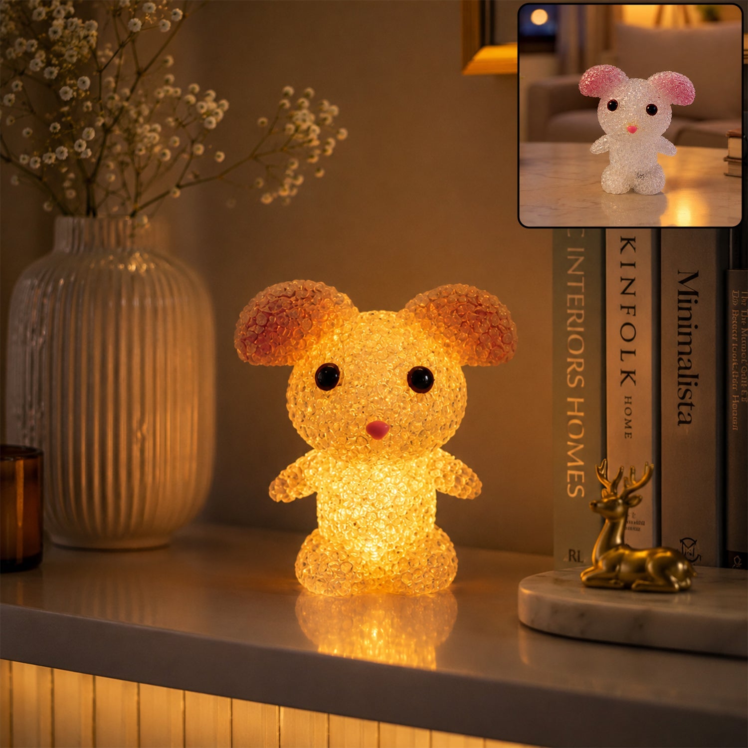 A yellow mouse-shaped crystal texture LED lamp glowing on a white shelf with a vase and a golden deer figurine.