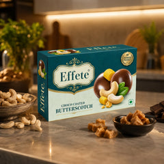 Effete Choco Coated Butterscotch box on a kitchen counter with cashews and butterscotch pieces scattered around.