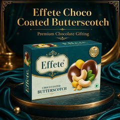 Effete Choco Coated Butterscotch box on a dark green pedestal with gold accents and draped fabric.