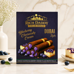 A dark purple box for Rich Daddy Cigar Rolls with blueberry cheesecake cream flavor, featuring illustrations of wafer rolls,