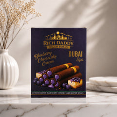 A purple box of Rich Daddy Cigar Rolls, blueberry cheesecake cream flavor, stands on a white marble surface next to a white