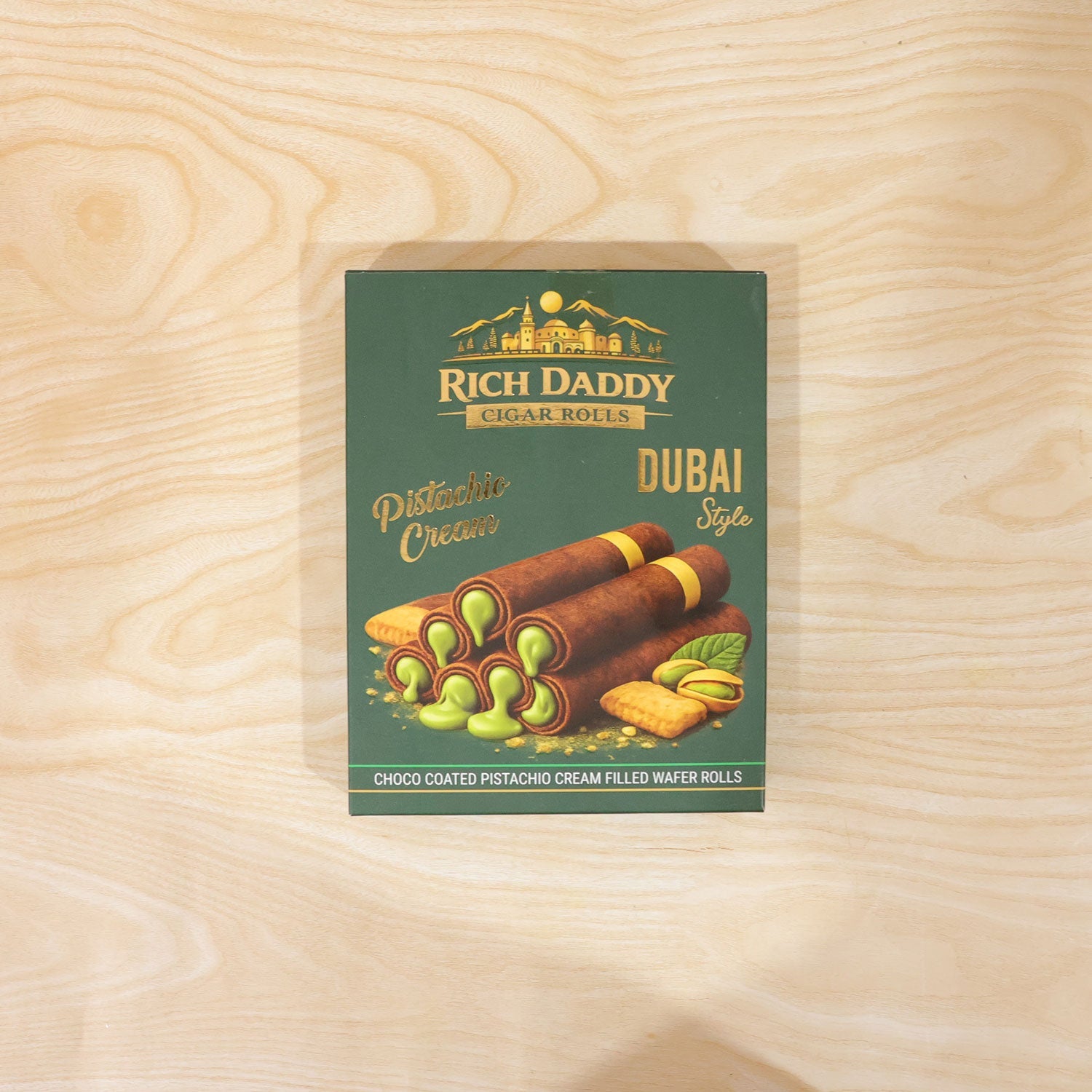 Green Rich Daddy Cigar Rolls box centered on a light wooden background.
